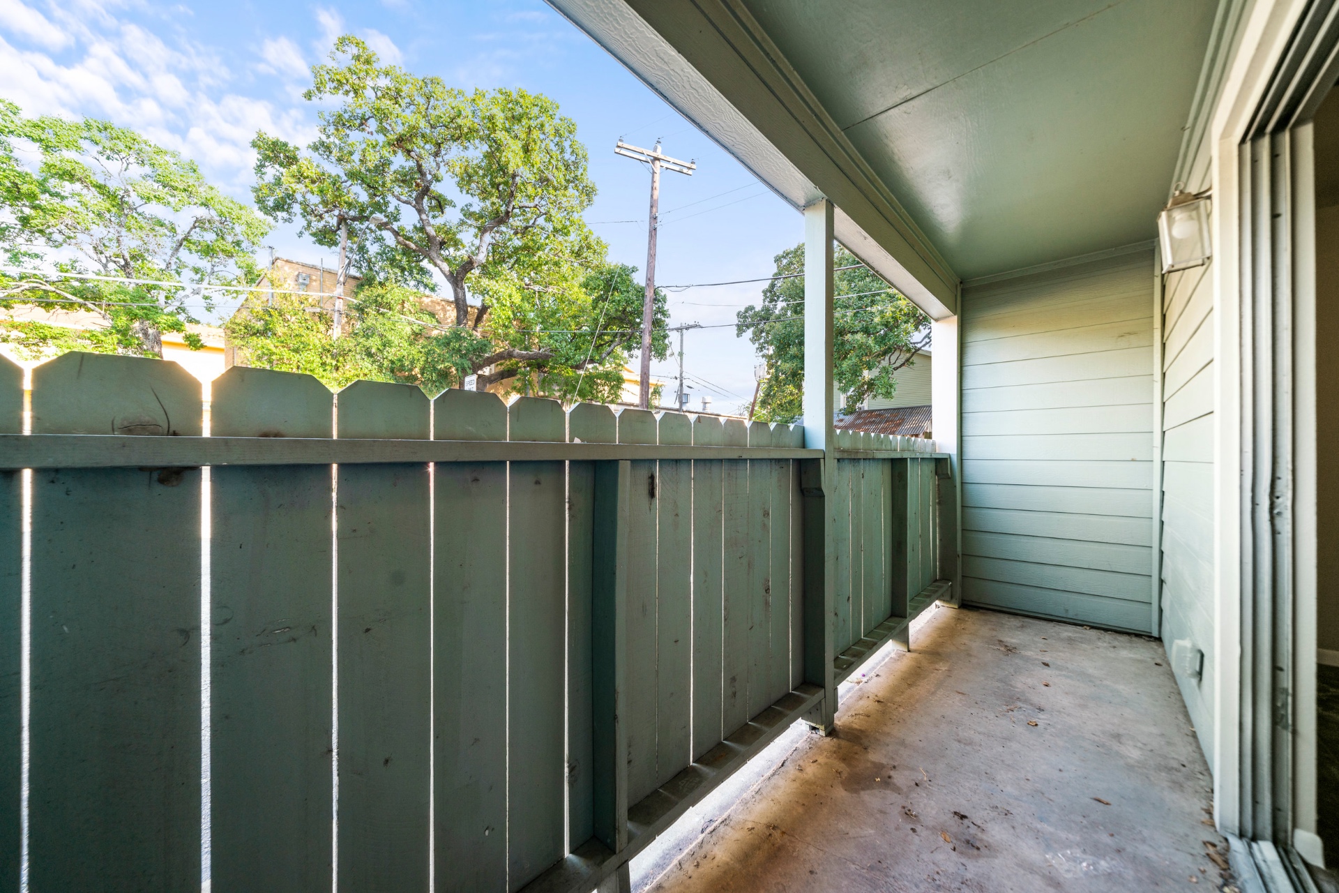 Covered balcony with tree-canopy view