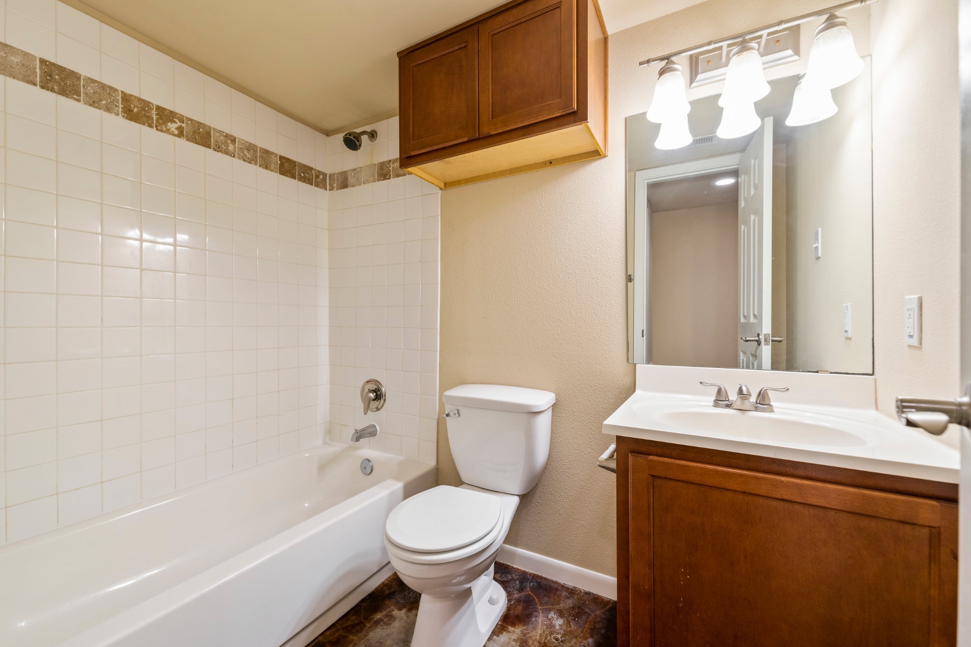 Full bathroom with tub, vanity, and storage