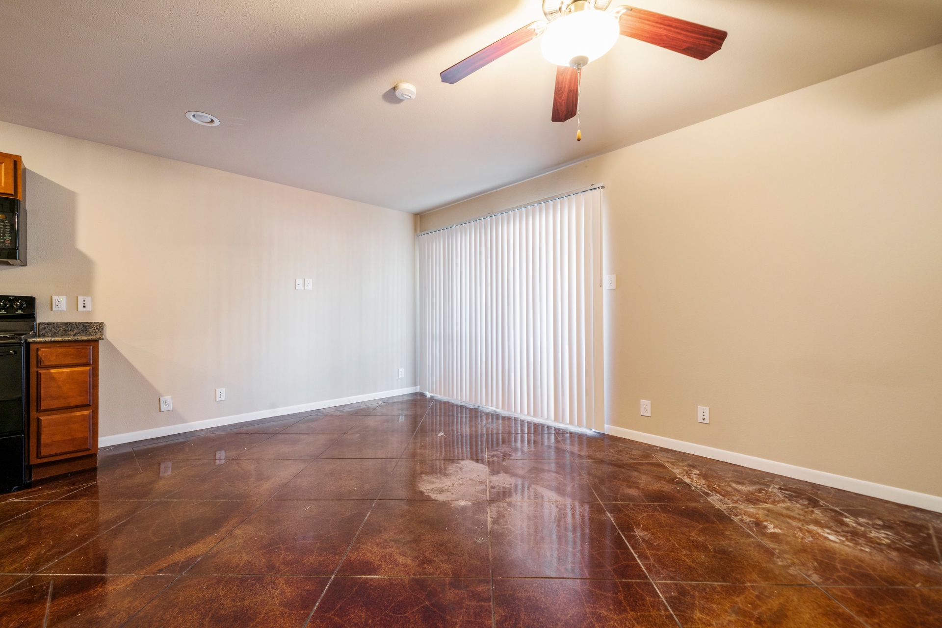 Open bedroom and living area with stained concrete floors