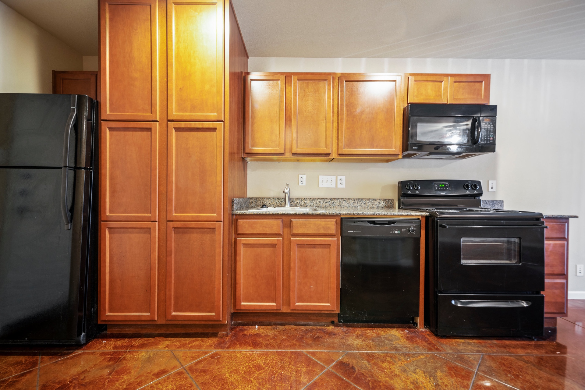 Kitchen cabinetry, granite counters, and full appliance package